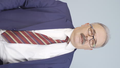 Vertical-video-of-Tired-old-businessman.